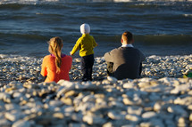 Family of three on pebble beach