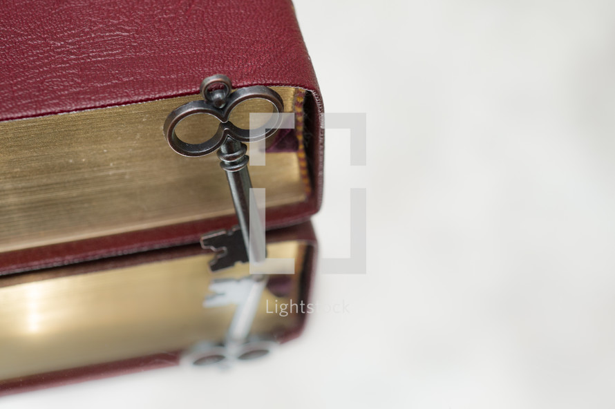 key leaning against a Bible