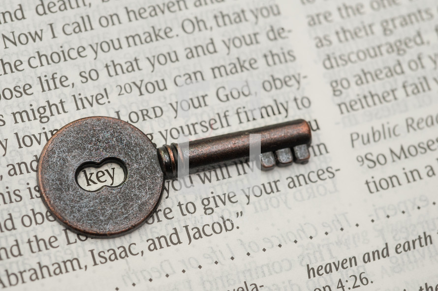 key on the pages of a Bible