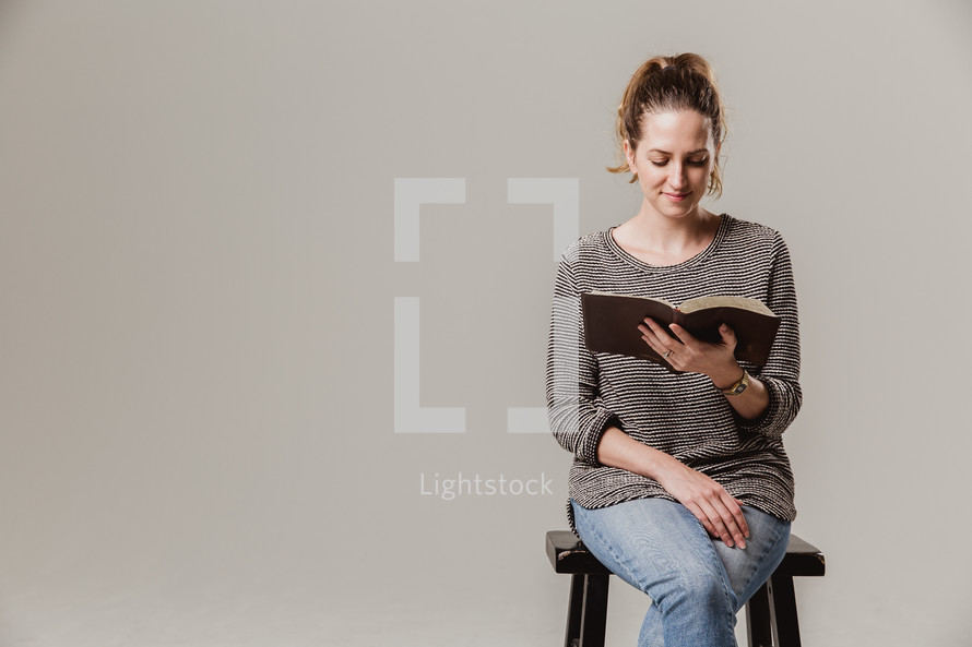 woman siting reading a Bible 