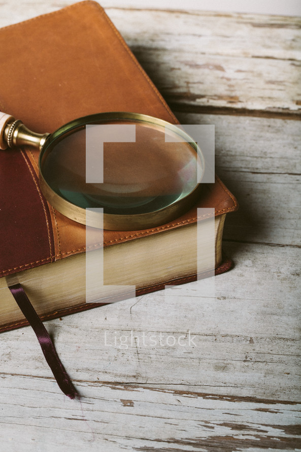 magnifying glass on a Bible