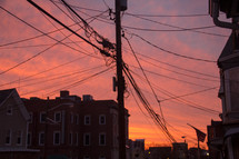 tangled power lines against the sky at sunset 