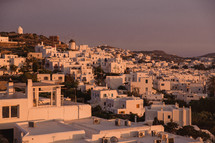 A city of white buildings on a hill.