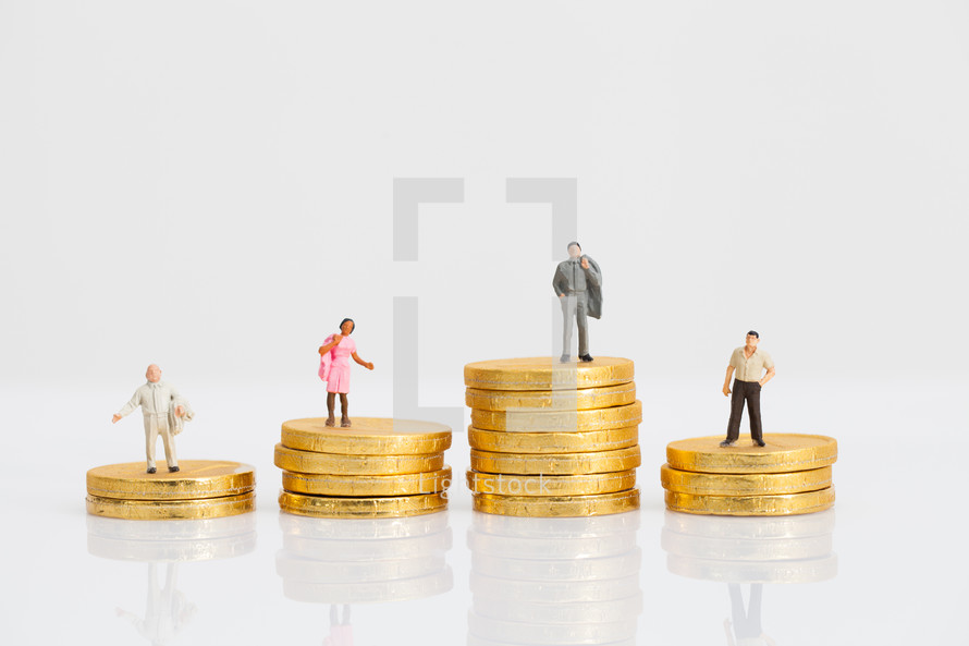 miniature figurines of people on gold coins 