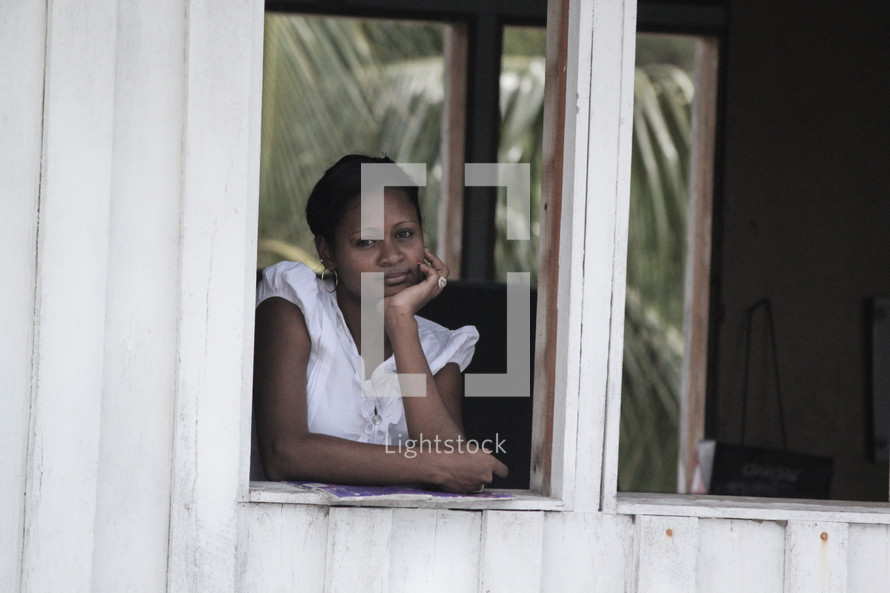 woman daydreaming in a window 