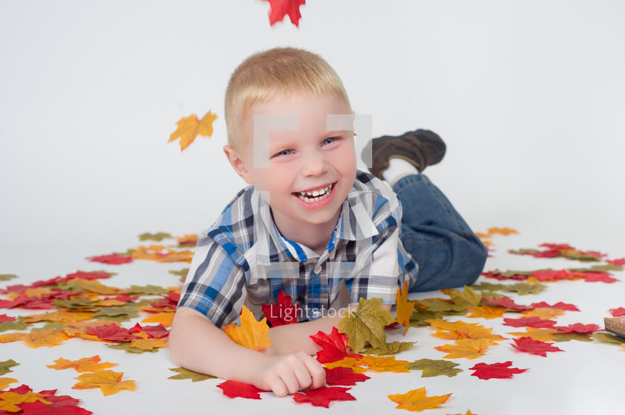 boy child and fall leaves