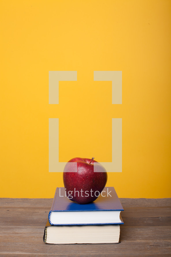 apple on a stack of books 