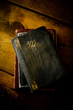 worn Bible on a wood table 