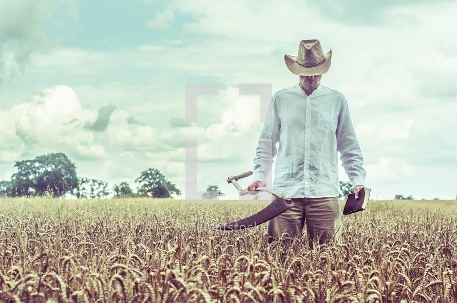 a farmer with a blade and a bible in a wheat field 