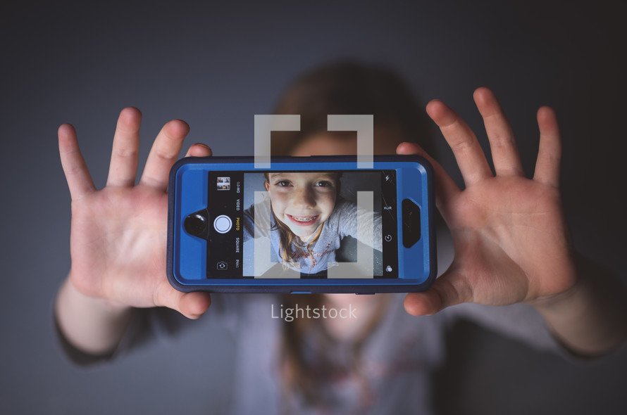 kid's selfie on a cellphone screen 