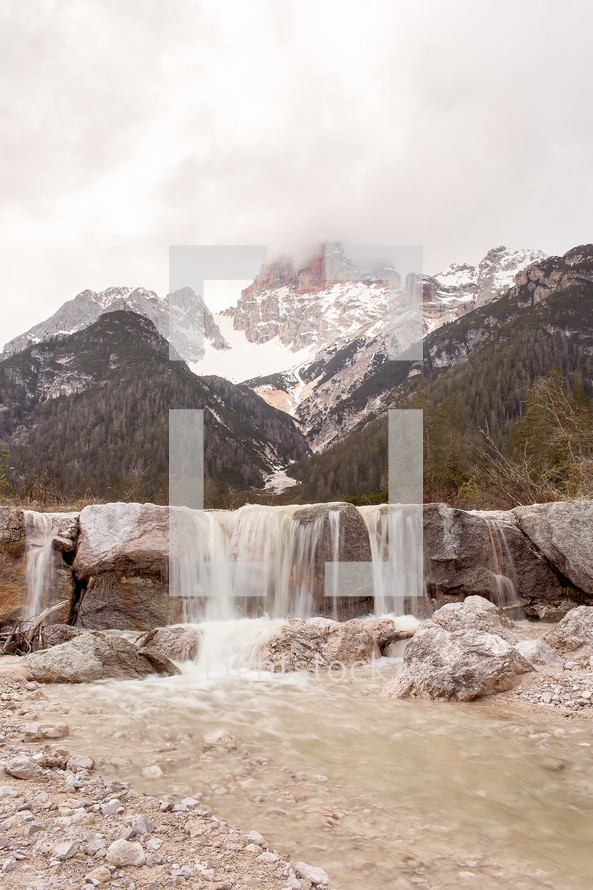 waterfall and snow on mountain peaks 