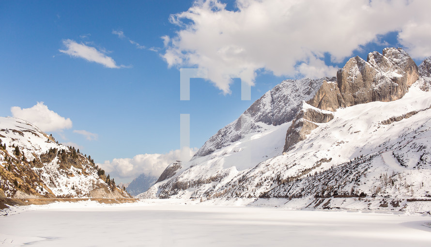 jagged mountain peaks and frozen lake 
