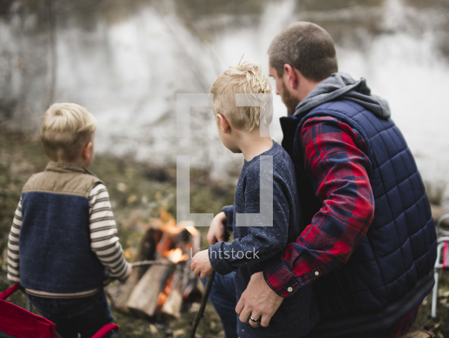 father and son's around a fire 