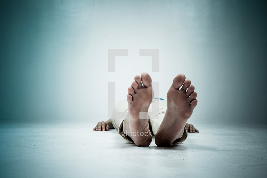 a woman lying on the floor with feet facing forward 