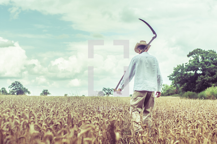 a man with a Scythe blade walking in a wheat field 