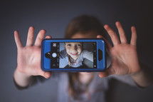 kid's selfie on a cellphone screen 