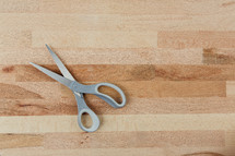 scissors on a wood cutting board