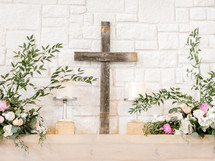 cross and flowers on an altar at a wedding 