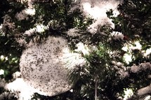 snow on a decorated Christmas tree