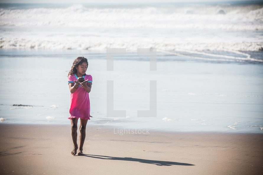 girl child walking on a beach 