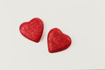 two red hearts on a white background 