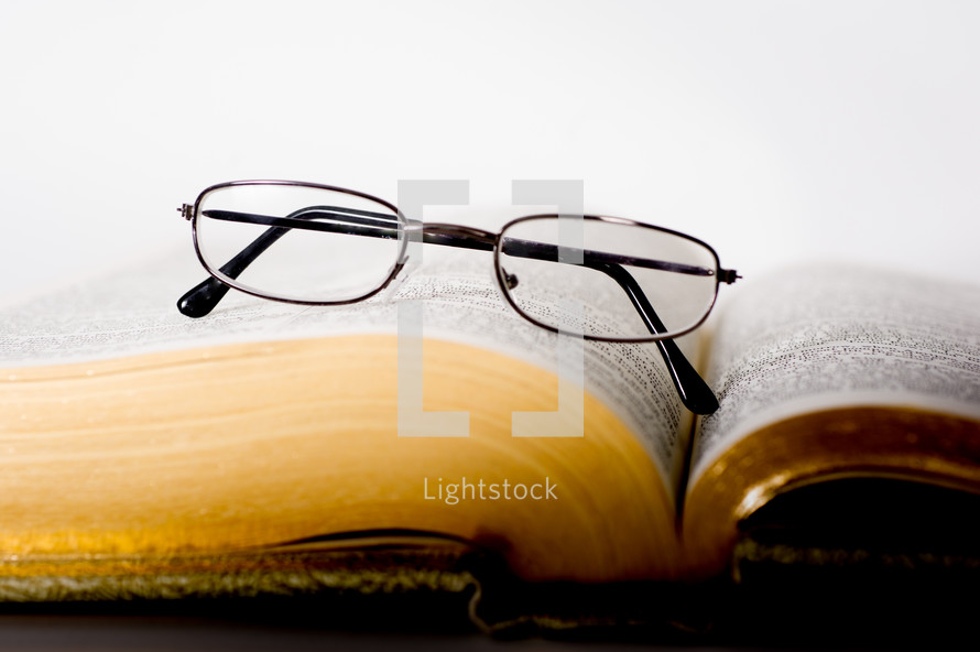 Glasses on an open bible.