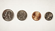A quarter, nickel, penny and dime isolated on white