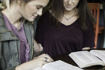 girls in prayer at a Bible study 