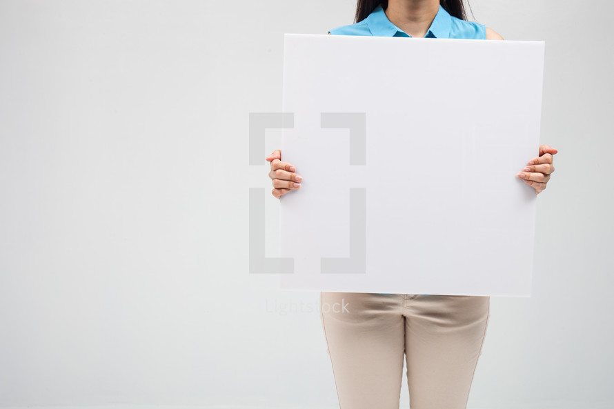 a woman holding up a blank sign 