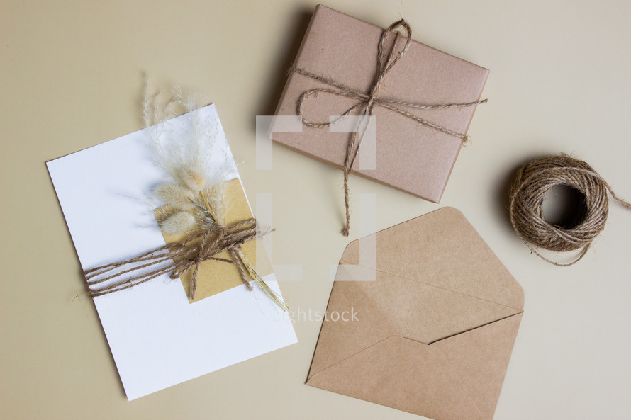 envelope with flowers and twine and gift 