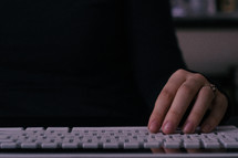 persons hand on computer keyboard