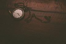 pocket watch on a table 
