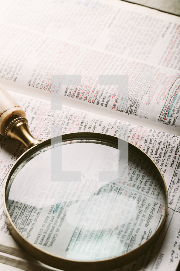 magnifying glass over Bible verse