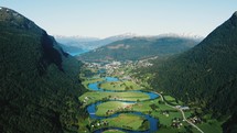 aerial view over a river and community in a valley in summer 