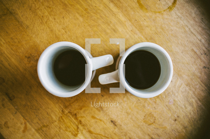 Two mugs of coffee on a table