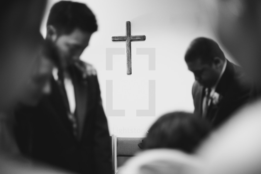 Floating wooden cross in center of prayer service.
