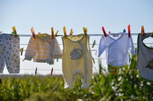 baby clothes drying at a laundry line. 