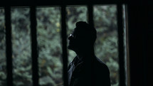 silhouette of a man looking up 