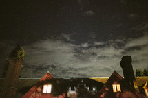 stars in a night sky over an inn