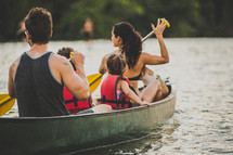 family rowing in a lake