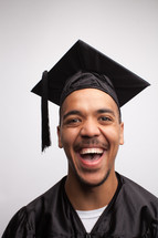 smiling graduate holding a diploma 
