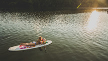 woman in a bikini on a paddle board 