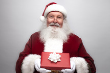 Santa Claus holding a Christmas gift 
