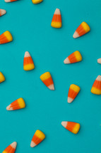 scattered candy corn on a blue background 
