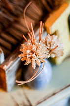 dried brown flowers in a vase 