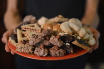 woman holding a plate of cookies