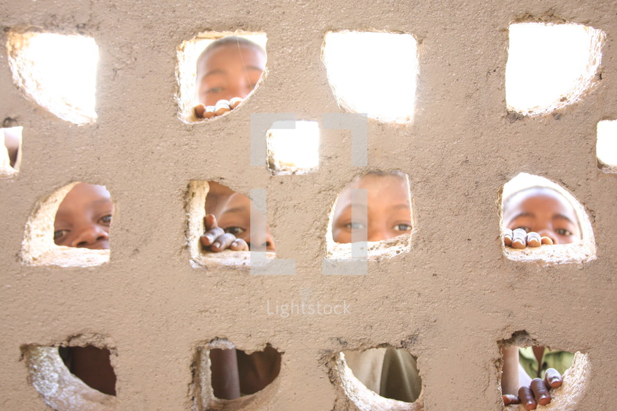 Children looking through small windows