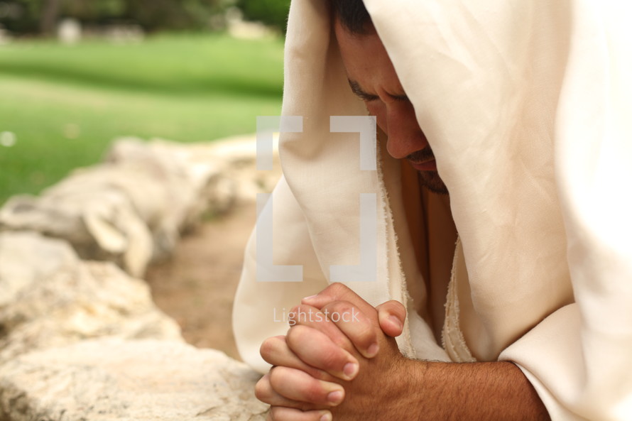 Jesus kneeled in prayer