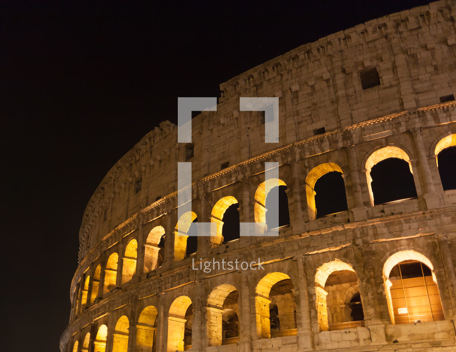 Majestic ancient Colosseum by night in Rome, Italy.