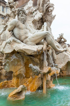 tatue of the god Zeus in Bernini's Fountain of the Four Rivers in Piazza Navona, Rome. Detail of the allegorical Ganges figure.